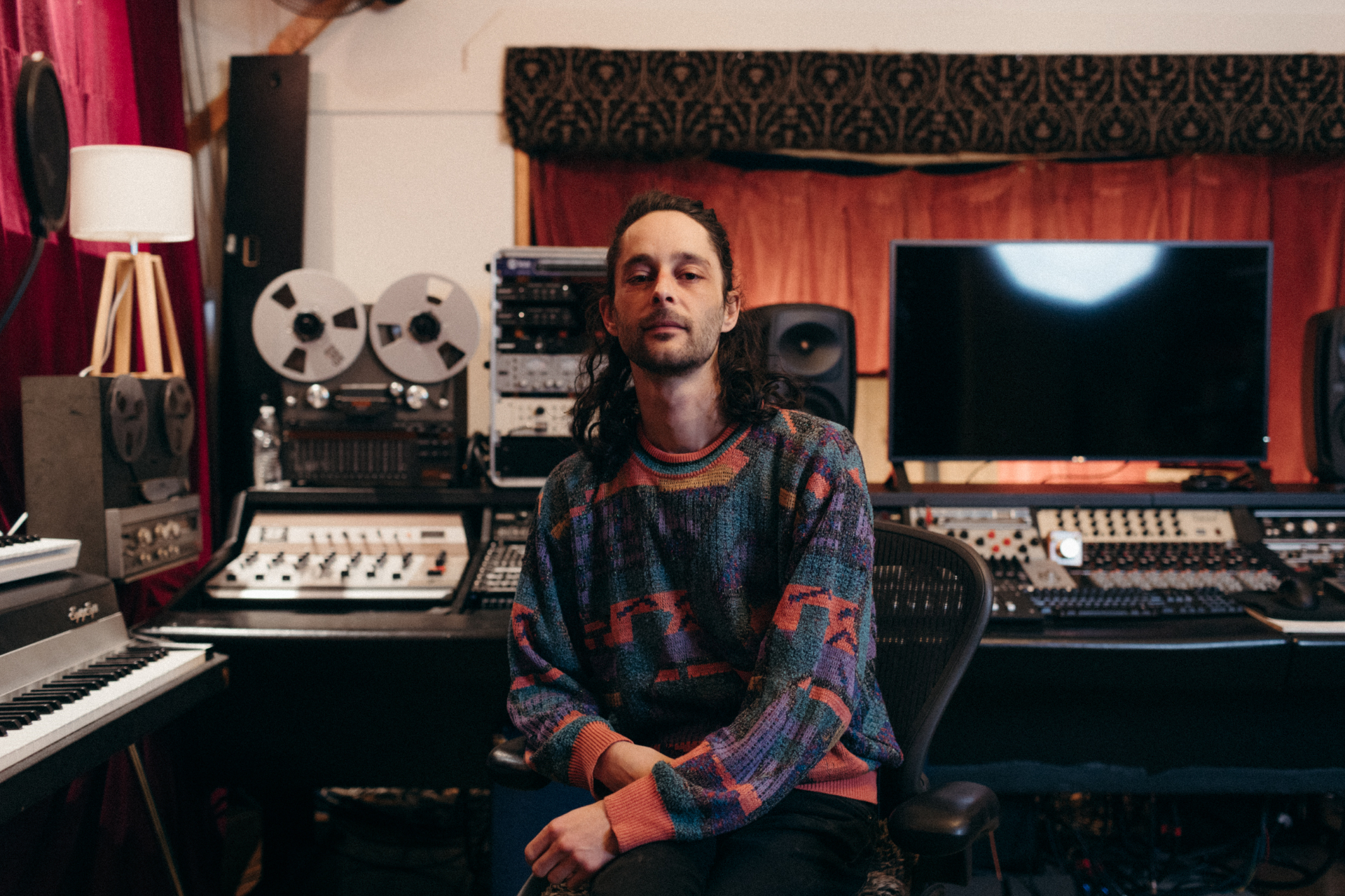 Nick Herrera seated in his recording studio
